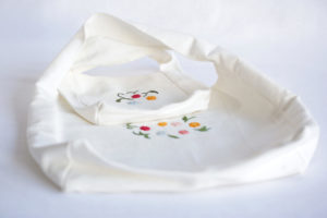 Gift bag for dairy products with hand-embroidered motif.
